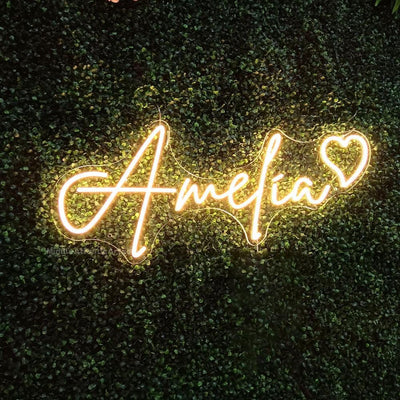 Amelia Name Neon sign by Neon.Outshine - adding a warm, elegant touch to a contemporary bedroom wall.