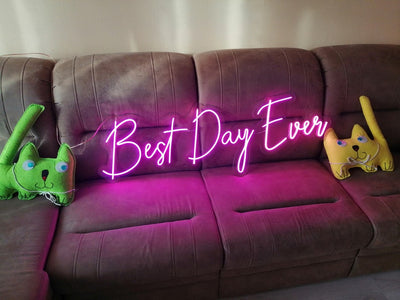 Best Day Ever LED neon sign glowing in white against a floral wedding backdrop — designed by Neon.Outshine for celebrations and events.