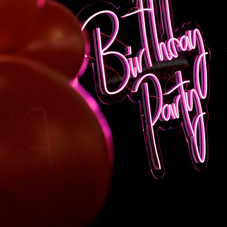 Birthday Party Neon Sign by Neon.Outshine glowing in bright neon color with festive lettering for party decor.