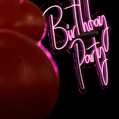 Birthday Party Neon Sign by Neon.Outshine glowing in bright neon color with festive lettering for party decor.