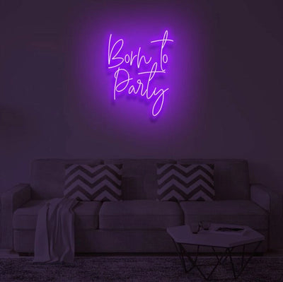 Born To Party LED neon sign glowing in vibrant colors, mounted on a wall in a party setting - Neon.Outshine 