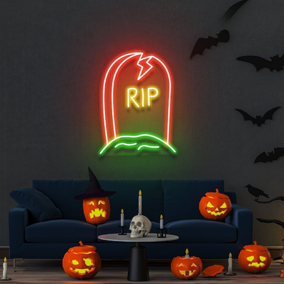GRAVE RIP Halloween neon sign by Neon.outshine, shaped like a tombstone on clear acrylic backing, glowing in a dark spooky room."