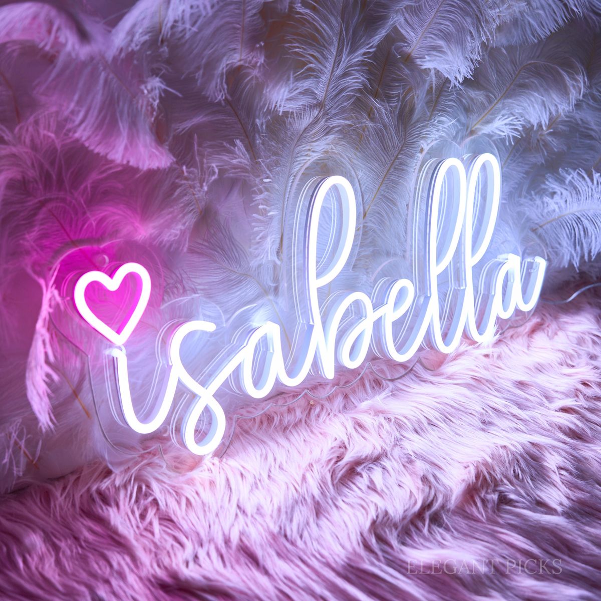 Isabella Name Neon sign By Neon.Outshine - in elegant script, casting a soft pink light on a bedroom wall.