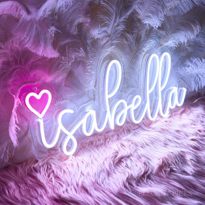 Isabella Name Neon sign By Neon.Outshine - in elegant script, casting a soft pink light on a bedroom wall.