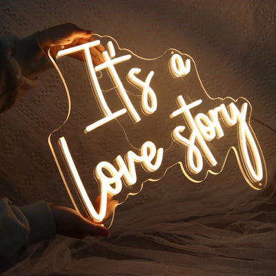 It’s a Love Story Wedding Neon Sign by Neon.Outshine glowing romantically behind on the  wedding backdrop