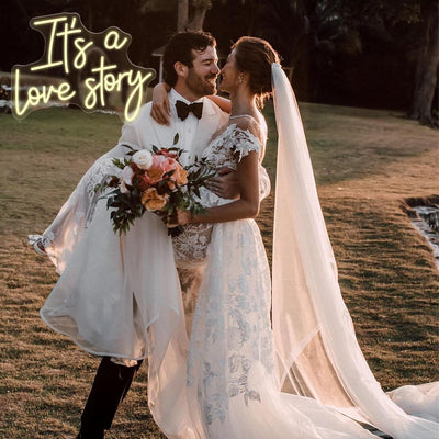 It’s a Love Story Wedding Neon Sign by Neon.Outshine glowing romantically behind on the  wedding backdrop