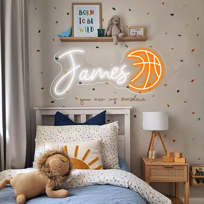 James Name neon sign above a child’s bed in a softly lit nursery - Neon.Outshine 