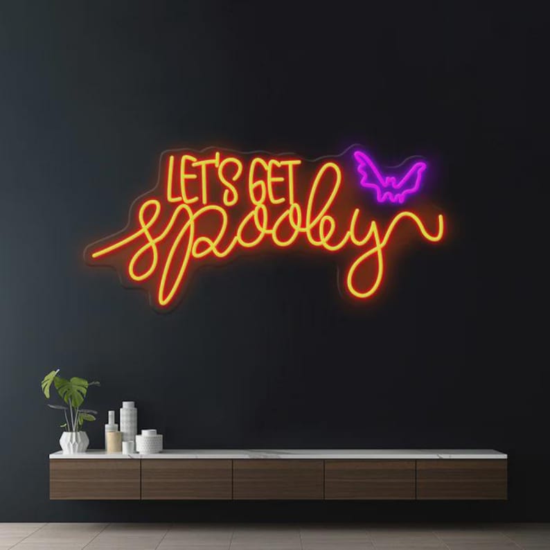 Let’s Get Spooky Halloween Neon Sign glowing in vibrant LED lights, ideal for festive Halloween décor and party backdrops by Neon.Outshine