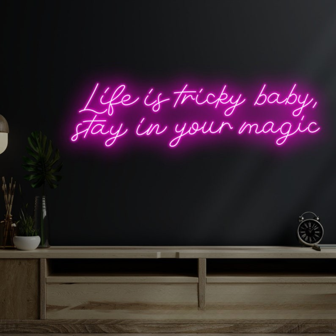 Life is Tricky Baby, Stay in Your Magic Neon sign in bright pink, glowing on a dark wall – handcrafted by Neon.Outshine.