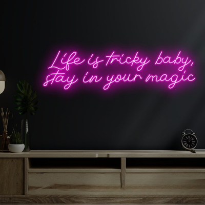 Life is Tricky Baby, Stay in Your Magic Neon sign in bright pink, glowing on a dark wall – handcrafted by Neon.Outshine.