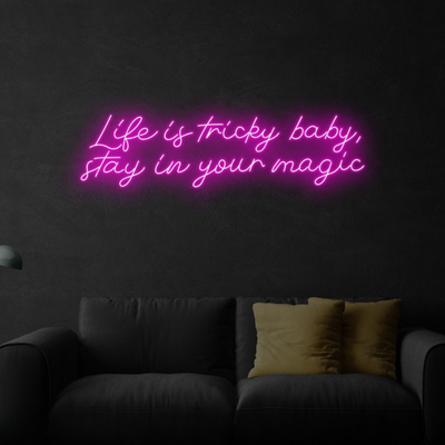 Life is Tricky Baby, Stay in Your Magic Neon sign in bright pink, glowing on a dark wall – handcrafted by Neon.Outshine.