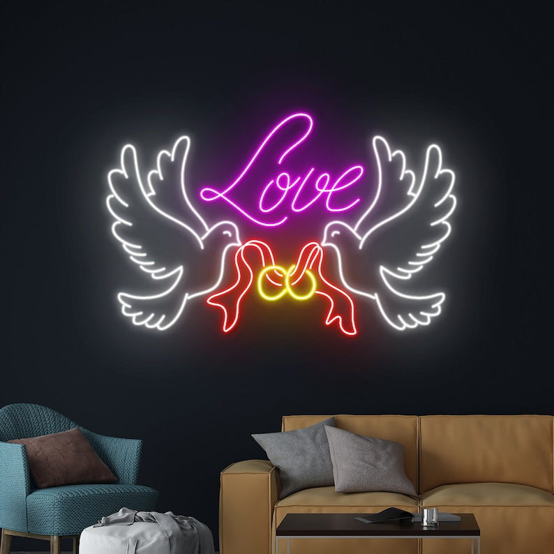 Love Dove Rings Wedding Neon Sign by Neon.Outshine glowing beautifully with doves and interlocking rings at a romantic wedding backdrop.