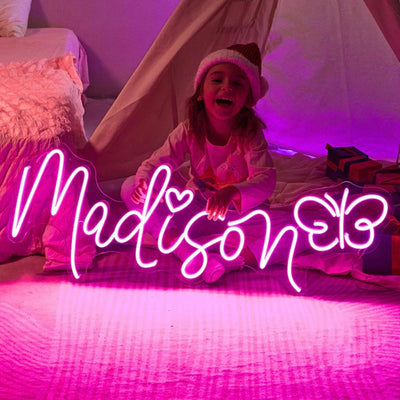 Madison Name Neon sign glowing brightly on a clear acrylic backing - Neon.Outshine 