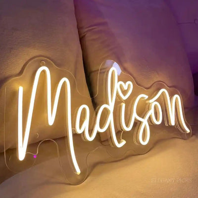 Madison Name Neon sign glowing brightly on a clear acrylic backing - Neon.Outshine 
