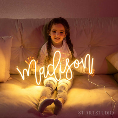 Madison Name Neon sign glowing brightly on a clear acrylic backing - Neon.Outshine 