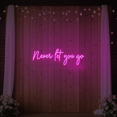 Never Let You Go Wedding Neon Sign by Neon.Outshine glowing beautifully behind a romantic wedding reception 