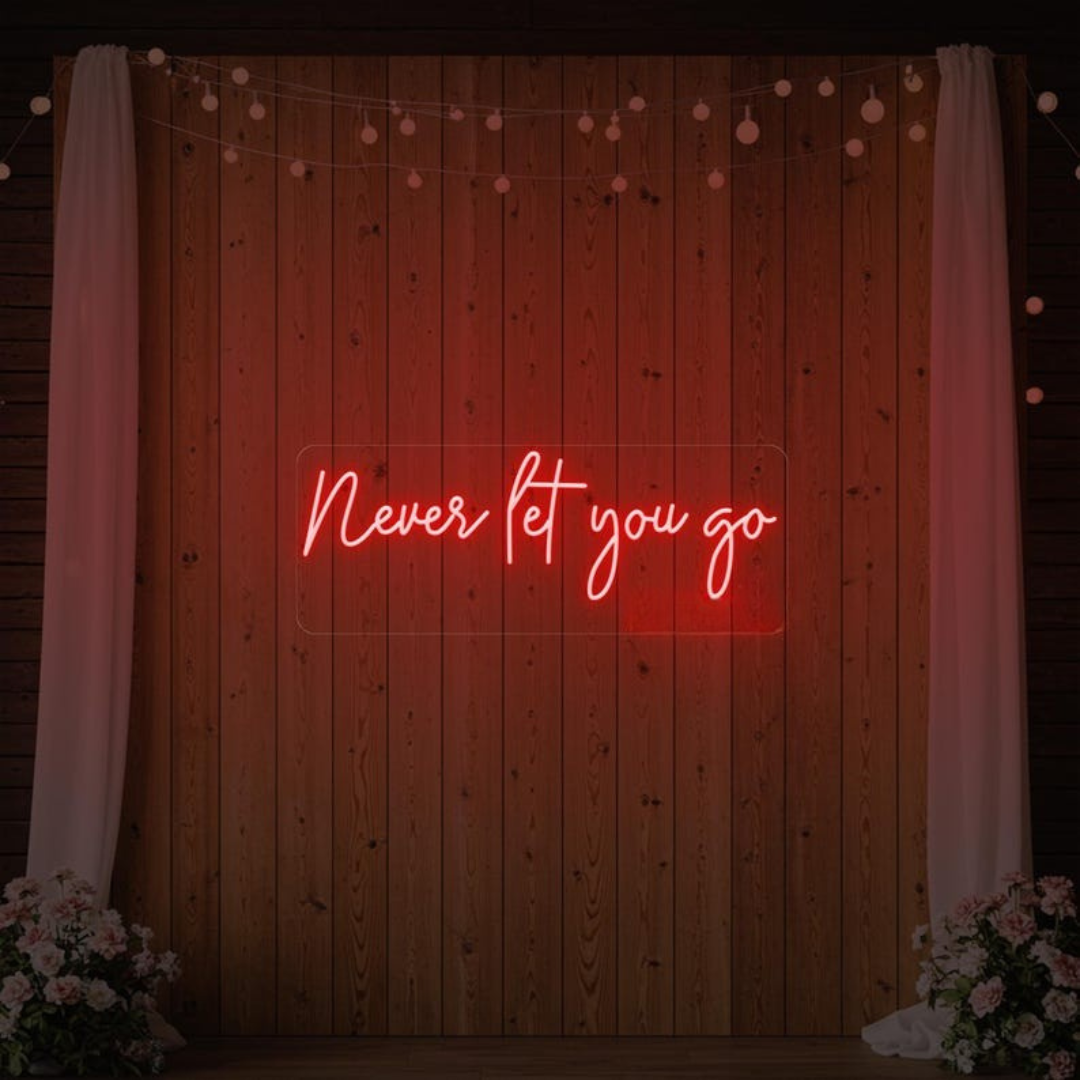 Never Let You Go Wedding Neon Sign by Neon.Outshine glowing beautifully behind a romantic wedding reception 