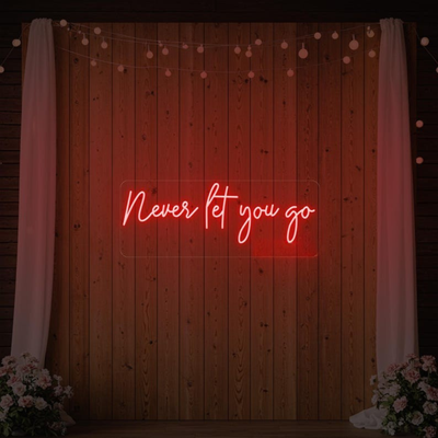 Never Let You Go Wedding Neon Sign by Neon.Outshine glowing beautifully behind a romantic wedding reception 