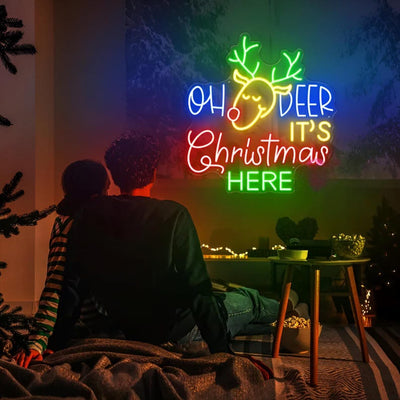 Oh Deer Christmas is Here Neon Sign by Neon.Outshine – playful LED neon light featuring holiday text with reindeer antlers for festive Christmas décor.