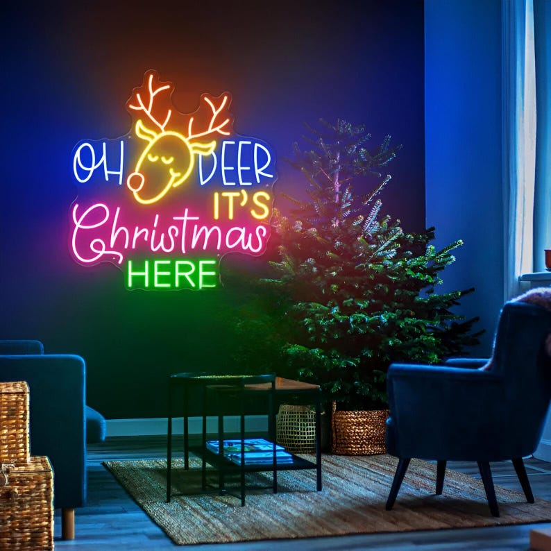 Oh Deer Christmas is Here Neon Sign by Neon.Outshine – playful LED neon light featuring holiday text with reindeer antlers for festive Christmas décor.