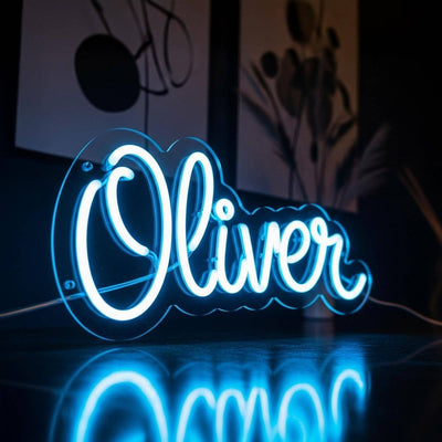  Oliver Name Neon sign by Neon.Outshine. - in vibrant glowing letters, mounted on a clear acrylic sheet and illuminating a cozy modern interior.