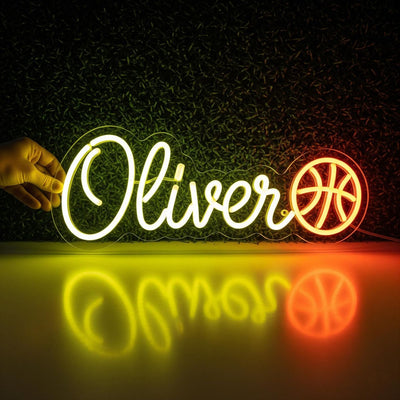  Oliver Name Neon sign by Neon.Outshine. - in vibrant glowing letters, mounted on a clear acrylic sheet and illuminating a cozy modern interior.