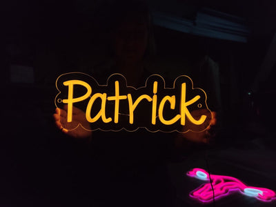 Patrick Name Neon sign glowing in warm white on bedroom wall - Neon.Outshine 