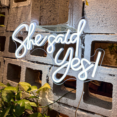 She Said Yes Wedding Neon Sign by Neon.Outshine glowing in elegant LED light at an engagement celebration backdrop.