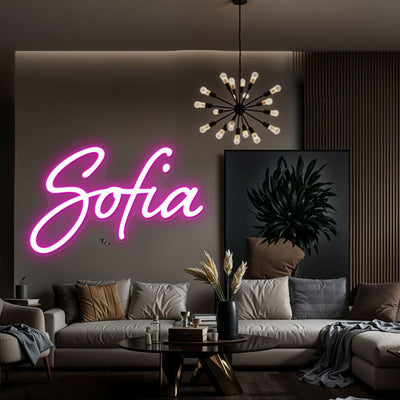 Sofia Name Neon sign by Neon.Outshine - in glowing cursive letters, mounted on clear acrylic and softly lighting a feminine, modern interior.