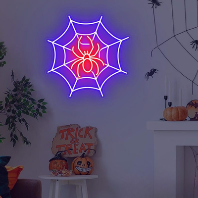Spider web neon sign by Neon.outshine in glowing  LED Lights mounted on clear acrylic in a dark Halloween room.