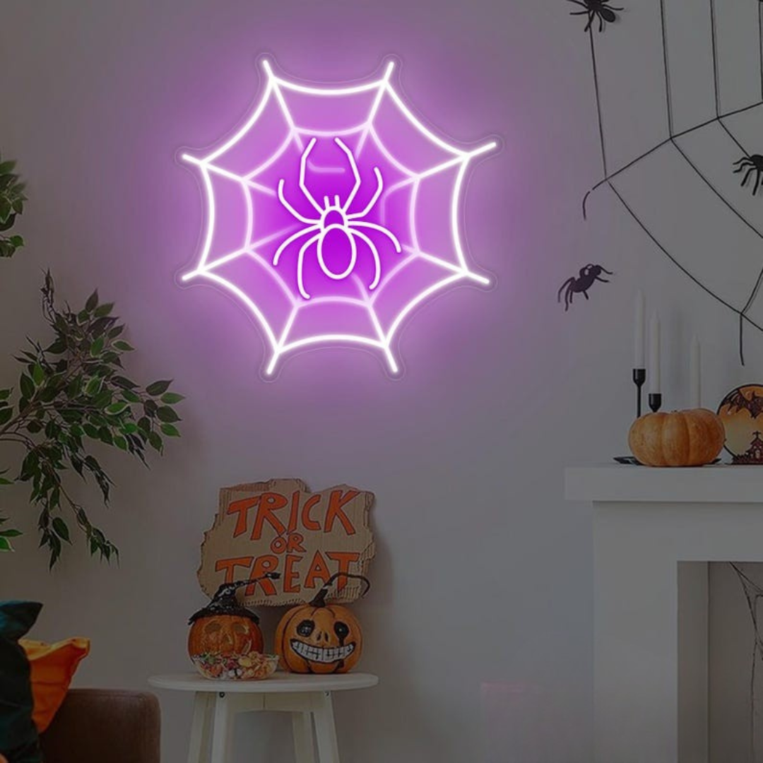 Spider web neon sign by Neon.outshine in glowing  LED Lights mounted on clear acrylic in a dark Halloween room.