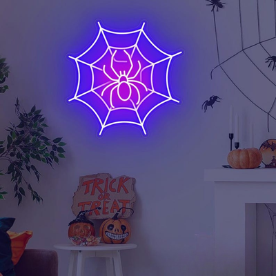 Spider web neon sign by Neon.outshine in glowing  LED Lights mounted on clear acrylic in a dark Halloween room.