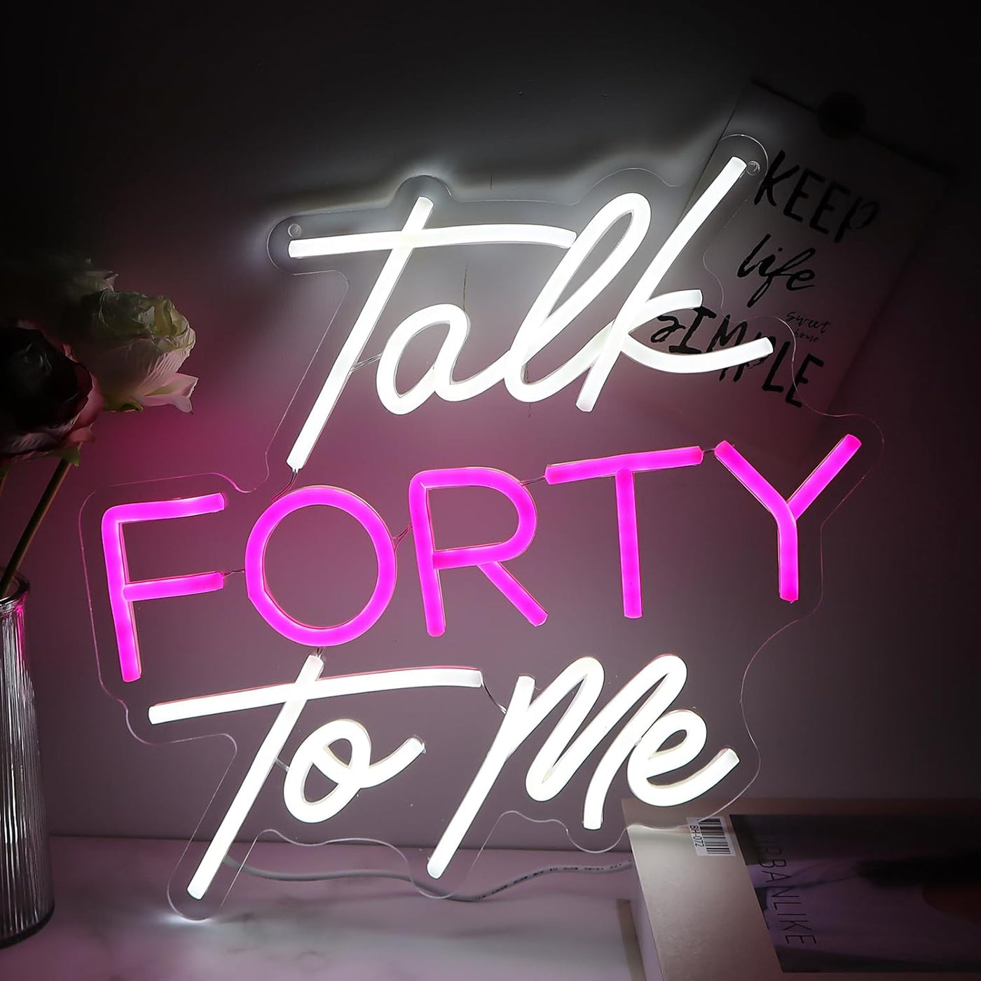 Talk Forty To Me LED neon sign in hot pink, glowing on a party wall  - designed by Neon.Outshine for 40th birthday celebrations.