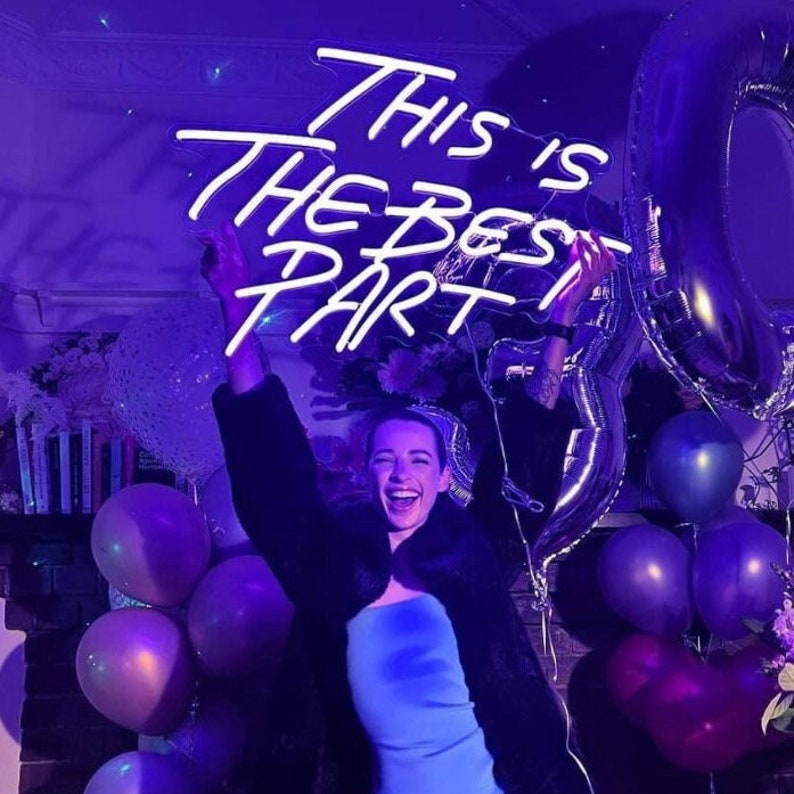This is the Best Part” neon sign in vibrant LED lighting, mounted on a clear acrylic board, glowing in a stylish indoor space – Neon.Outshine 
