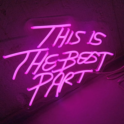 This is the Best Part” neon sign in vibrant LED lighting, mounted on a clear acrylic board, glowing in a stylish indoor space – Neon.Outshine 