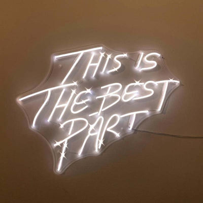This is the Best Part” neon sign in vibrant LED lighting, mounted on a clear acrylic board, glowing in a stylish indoor space – Neon.Outshine 