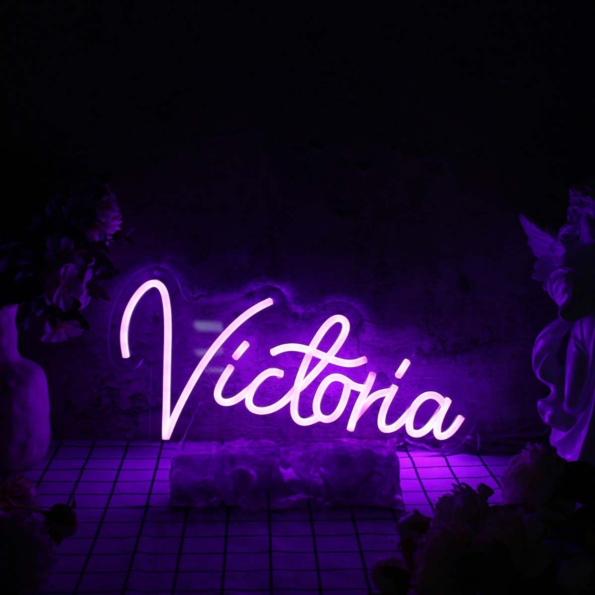 Victoria Name Neon sign by Neon.Outshine - mounted on a clear acrylic backing and softly illuminating a modern interior wall.