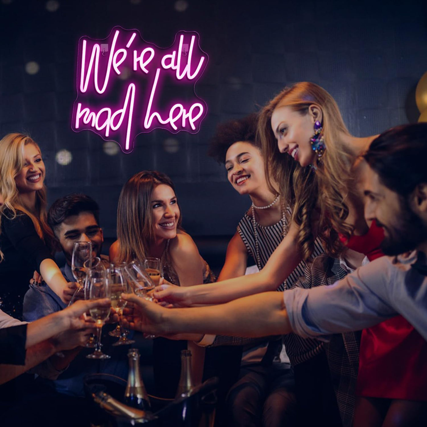 We’re All Mad Here LED neon sign glowing in bright colors on a wall at a party by Neon.Outshine 