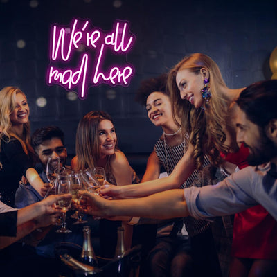 We’re All Mad Here LED neon sign glowing in bright colors on a wall at a party by Neon.Outshine 