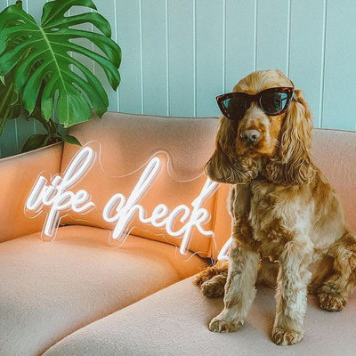 Vibe Check neon sign by Neon.Outshine - glowing LED lettering mounted on clear acrylic